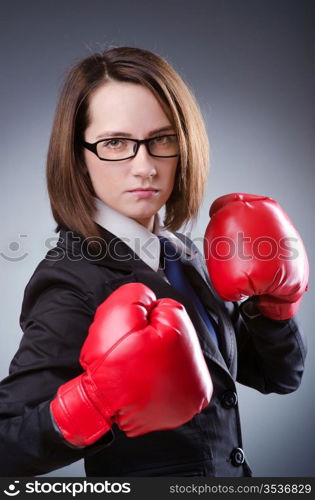 Young businesswoman in boxing concept