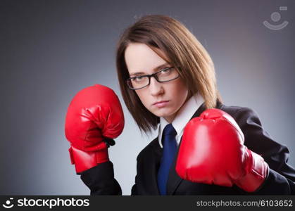 Young businesswoman in boxing concept