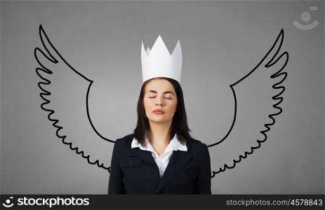 Young businesswoman in crown and with drawn wings behind back. I want to fly away