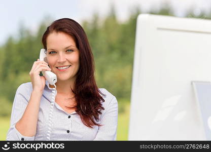 Young businesswoman in nature attractive smiling calling sitting behind table