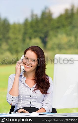 Young businesswoman in nature attractive smiling calling sitting behind table