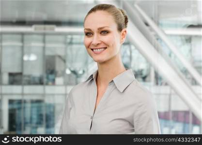 Young businesswoman in office, smiling