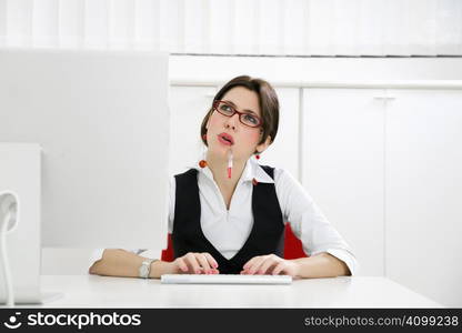 Young businesswoman in office typing on computer