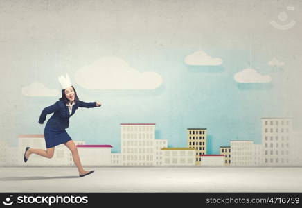 Young businesswoman in paper crown running in a hurry