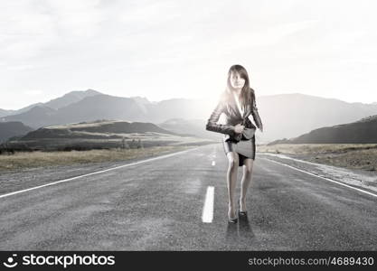 Young businesswoman in start position ready to run