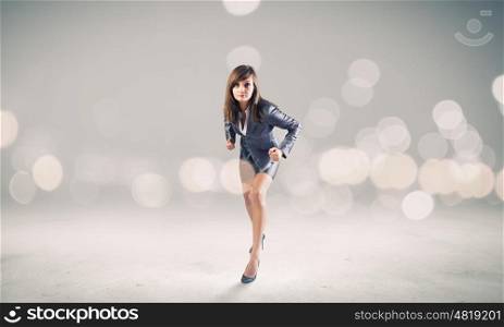 Young businesswoman in start position ready to run