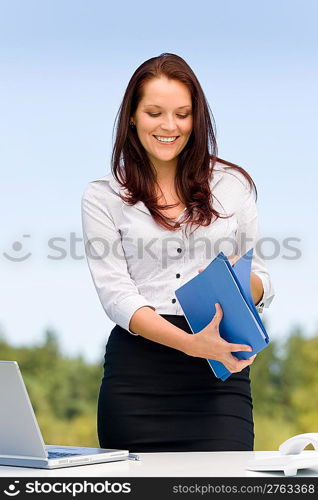 Young businesswoman in sunny nature attractive smiling hold folders