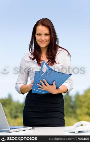 Young businesswoman in sunny nature attractive smiling hold folders