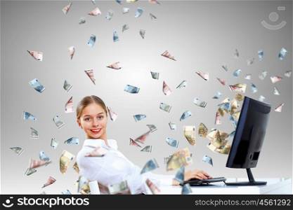 Young businesswoman in the office with money banknotes around her