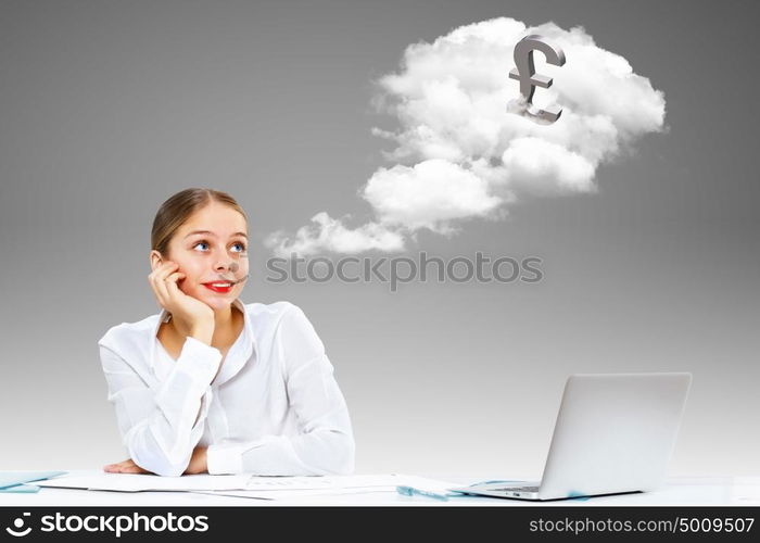 Young businesswoman in the office with money banknotes around her