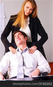 young businesswoman is making head massage to her teammate