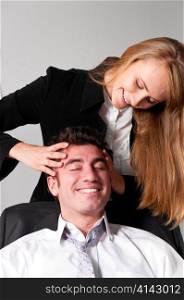 young businesswoman is making head massage to her teammate