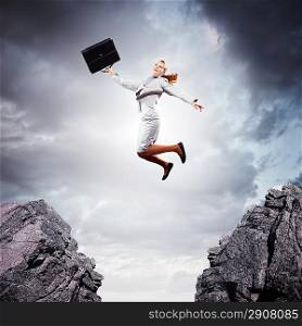 Young businesswoman jumping