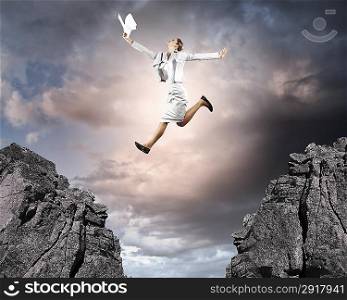 Young businesswoman jumping