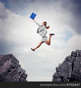 Young businesswoman jumping. Image of young businesswoman jumping over gap
