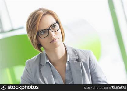 Young businesswoman looking away in office