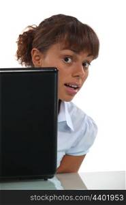 young businesswoman looking over her laptop