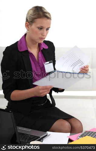 Young businesswoman looking through a report