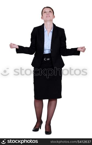 young businesswoman looking upwards tight-fisted