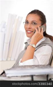 Young businesswoman on the phone sitting at office