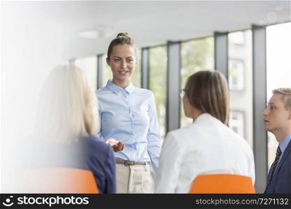 Young businesswoman planning strategy with colleagues during meeting at office