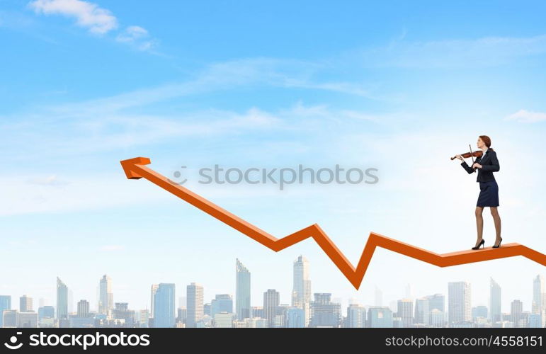 Young businesswoman playing violin and financial graphs at background. Melody of success