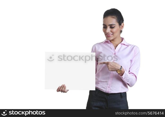 Young businesswoman pointing at black card over white background
