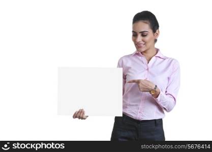 Young businesswoman pointing at black card over white background
