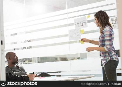 Young businesswoman presenting ideas to male colleagues