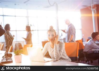 Young businesswoman programer in big bright office at work using computer