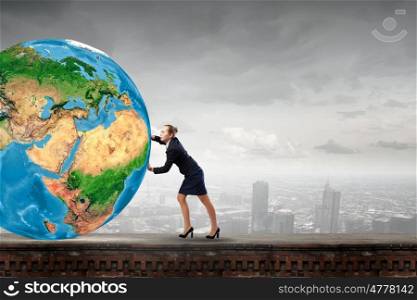 Young businesswoman pushing Earth planet. Elements of this image are furnished by NASA. Planet in danger