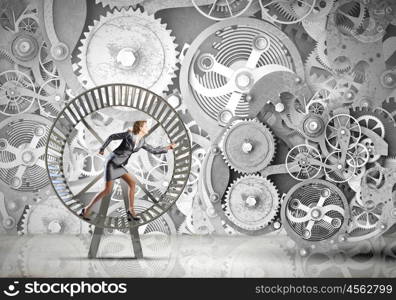 Young businesswoman running in wheel of gears mechanism. Always busy at work