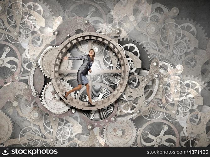 Young businesswoman running in wheel of gears mechanism. Always busy at work