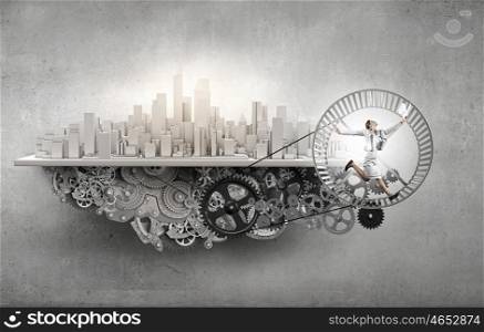 Young businesswoman running in wheel of gears mechanism. To turn as squirrel in wheel