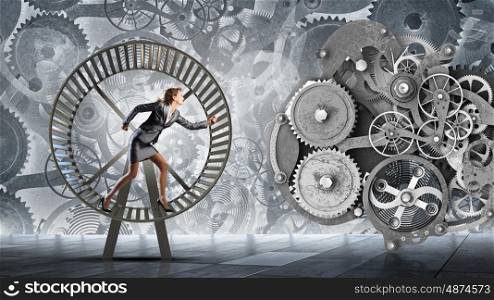Young businesswoman running in wheel of gears mechanism. To turn as squirrel in wheel