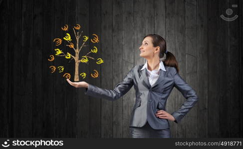 Young businesswoman showing money tree in her hand. Money tree