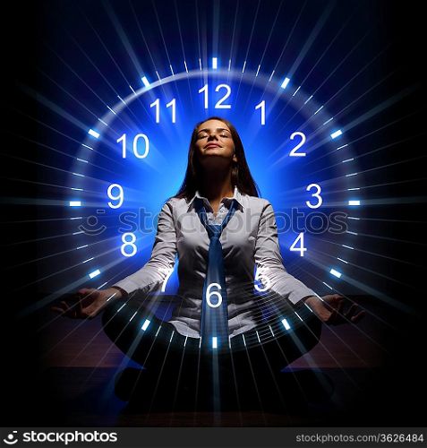 Young businesswoman sitting against blue background with clock interface