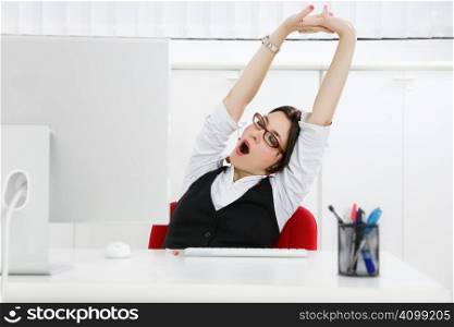 Young businesswoman sitting at desk yawning. Copy space