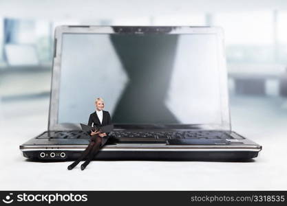 Young businesswoman sitting on a laptop