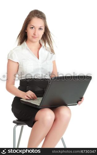 young businesswoman sitting on chair with laptop, isolated on white