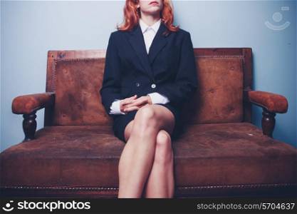 Young businesswoman sitting on sofa