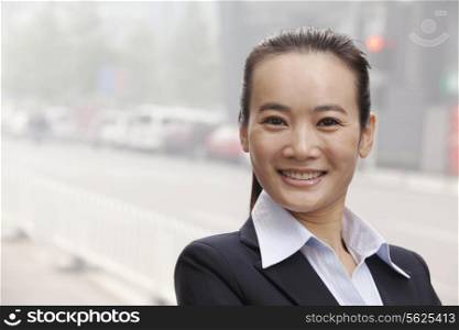 Young Businesswoman Smiling and Looking At Camera