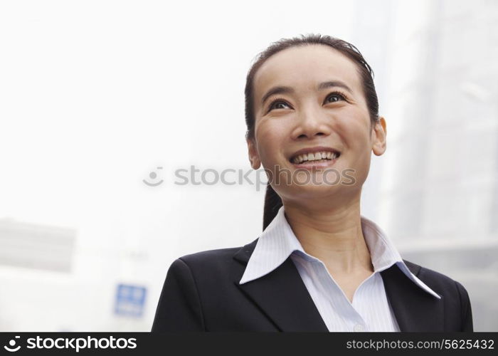 Young Businesswoman Smiling and Looking into the Distance