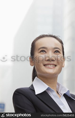 Young Businesswoman Smiling and Looking into the Distance