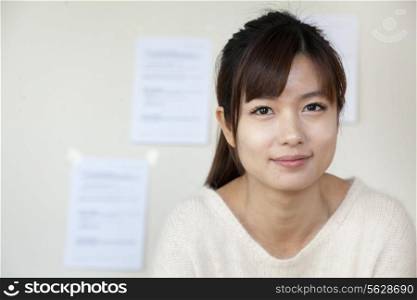 Young businesswoman smiling in the office, portrait