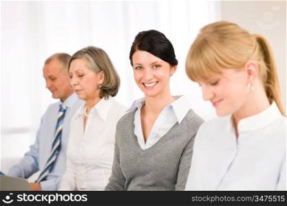 Young businesswoman smiling meeting with team colleagues