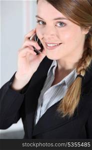Young businesswoman smiling on the phone.