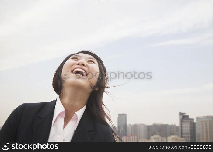Young businesswoman smiling with hair blowing