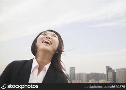 Young businesswoman smiling with hair blowing