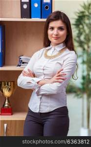 Young businesswoman standing next to shelf